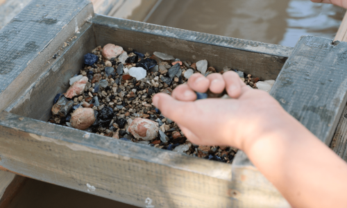 Close up of a child holding gemstones after gemstone panning at 1880 Town